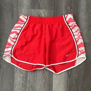 Nike Dri Fit women’s red running shorts probably a medium white pinkish side